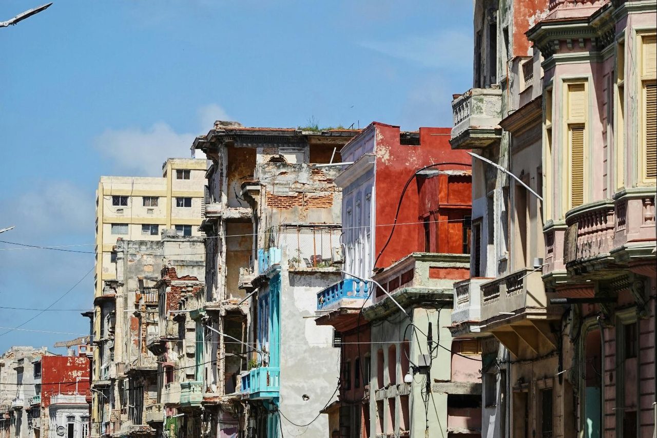 Facades from different eras on a street in Havana